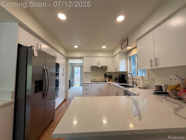 4178 Breckenridge Dr, West Bloomfield, MI 48322 - kitchen with black appliances, a peninsula, white cabinetry, light stone counters, and under cabinet range hood