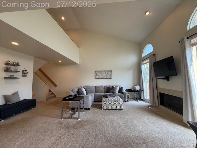 4178 Breckenridge Dr, West Bloomfield, MI 48322 - carpeted living room with high vaulted ceiling, stairs, recessed lighting, and a tile fireplace