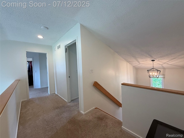 4178 Breckenridge Dr, West Bloomfield, MI 48322 - hallway with an upstairs landing, a textured ceiling, carpet flooring, and a chandelier