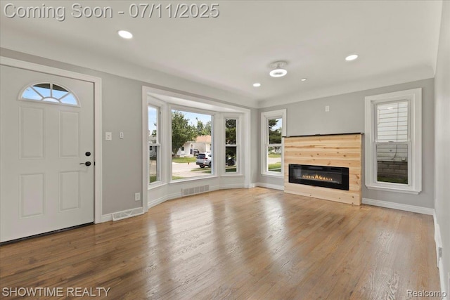 23041 Shakespeare Ave, Eastpointe, MI 48021 - unfurnished living room featuring wood finished floors, recessed lighting, and a glass covered fireplace