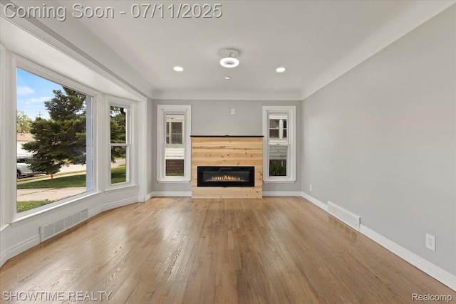 23041 Shakespeare Ave, Eastpointe, MI 48021 - unfurnished living room featuring a glass covered fireplace, wood finished floors, and recessed lighting