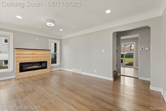 23041 Shakespeare Ave, Eastpointe, MI 48021 - unfurnished living room with a glass covered fireplace, wood finished floors, and recessed lighting