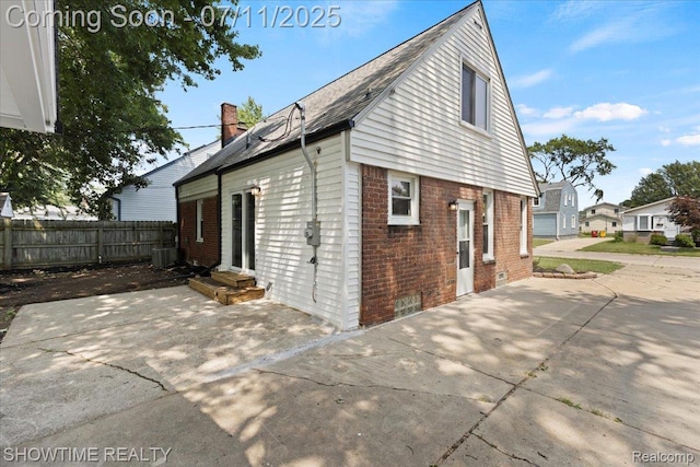 23041 Shakespeare Ave, Eastpointe, MI 48021 - view of side of property with brick siding, a patio, a chimney, and entry steps