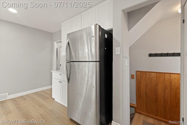 23041 Shakespeare Ave, Eastpointe, MI 48021 - kitchen featuring freestanding refrigerator, light wood-style flooring, white cabinets, light countertops, and recessed lighting