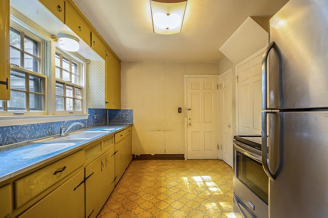 303 Wesley St, Ann Arbor, MI 48103 - kitchen featuring stainless steel appliances, wallpapered walls, and light floors