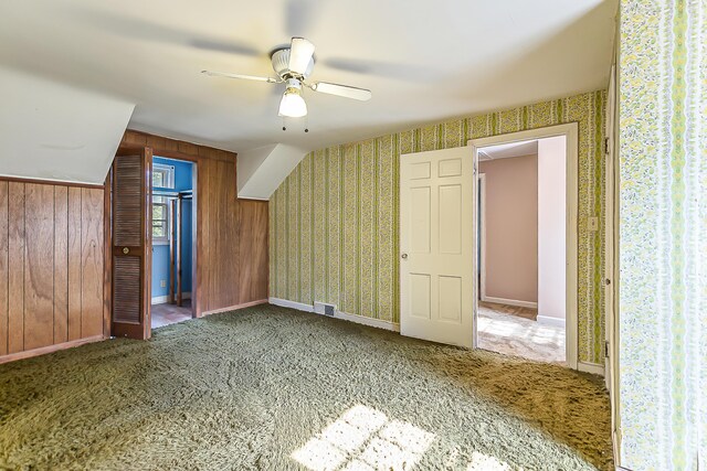 303 Wesley St, Ann Arbor, MI 48103 - additional living space featuring carpet, a ceiling fan, and wood walls