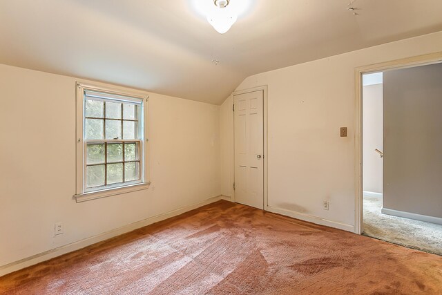 303 Wesley St, Ann Arbor, MI 48103 - unfurnished room featuring vaulted ceiling and carpet