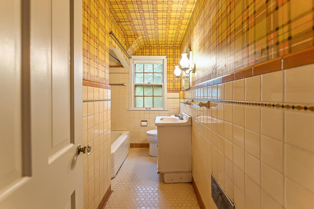 303 Wesley St, Ann Arbor, MI 48103 - full bath featuring a tub to relax in, vanity, tile patterned floors, and tile walls