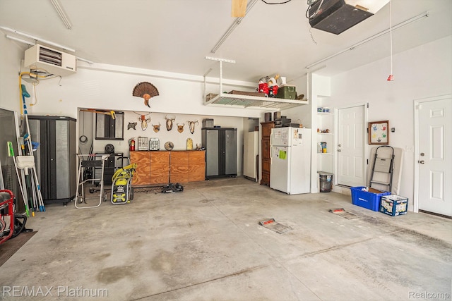 16344 Waterview Ln, Linden, MI 48451 - garage with freestanding refrigerator, a garage door opener, and a heating unit