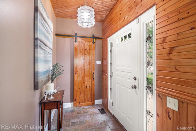 16344 Waterview Ln, Linden, MI 48451 - foyer entrance featuring stone tile flooring, a barn door, and a chandelier