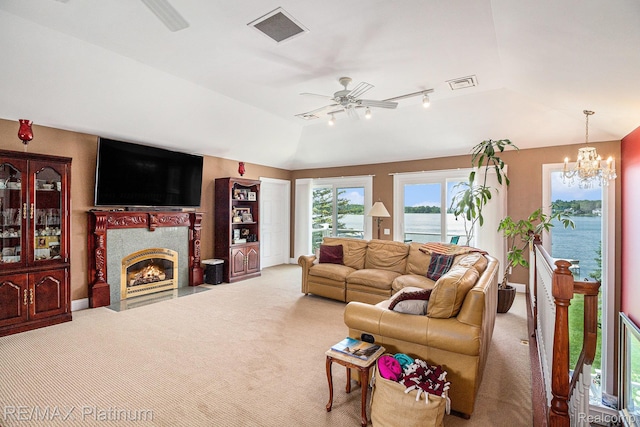16344 Waterview Ln, Linden, MI 48451 - carpeted living room featuring vaulted ceiling, a ceiling fan, a chandelier, and a fireplace with flush hearth