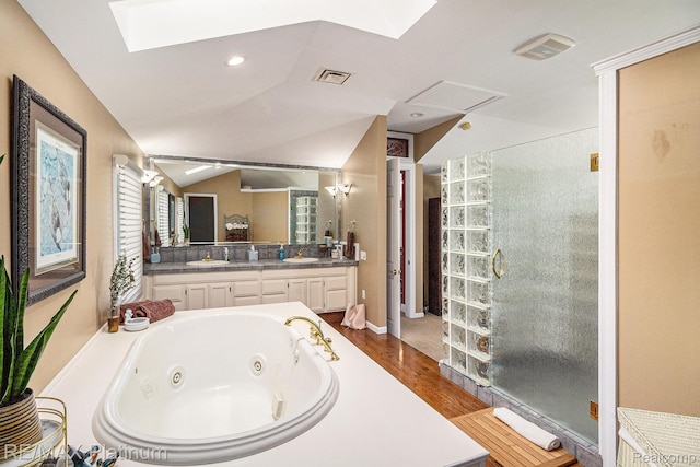 16344 Waterview Ln, Linden, MI 48451 - bathroom featuring a skylight, double vanity, wood finished floors, a walk in shower, and a jetted tub