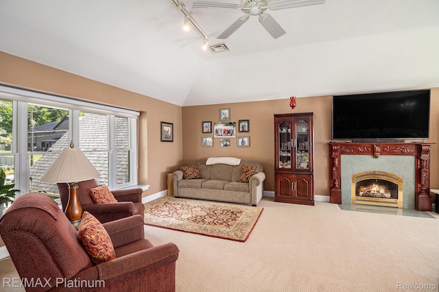 16344 Waterview Ln, Linden, MI 48451 - living room with a ceiling fan, track lighting, carpet flooring, vaulted ceiling, and a fireplace with flush hearth