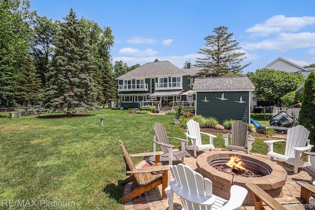 16344 Waterview Ln, Linden, MI 48451 - rear view of property with an outdoor fire pit, a shingled roof, a patio area, a balcony, and an outbuilding