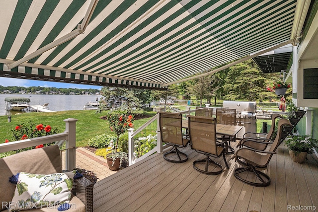 16344 Waterview Ln, Linden, MI 48451 - deck featuring outdoor dining area, a water view, a yard, and area for grilling