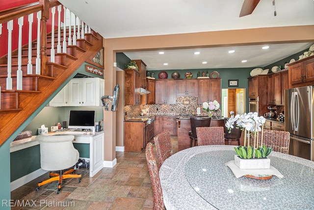 16344 Waterview Ln, Linden, MI 48451 - kitchen with stainless steel appliances, recessed lighting, tasteful backsplash, stone tile flooring, and built in study area