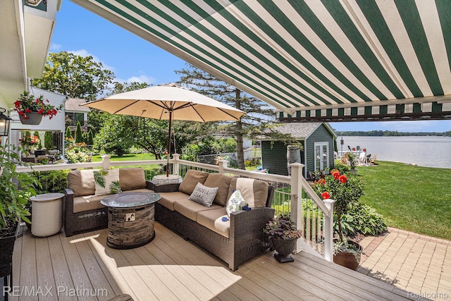 16344 Waterview Ln, Linden, MI 48451 - deck with a water view, an outdoor hangout area, an outdoor structure, and a lawn
