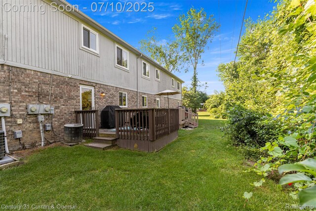 23486 Boller Ct, Trenton, MI 48183 - rear view of house featuring a deck, a lawn, and brick siding