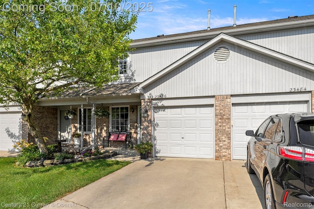 23486 Boller Ct, Trenton, MI 48183 - traditional-style home featuring covered porch, concrete driveway, a garage, and brick siding