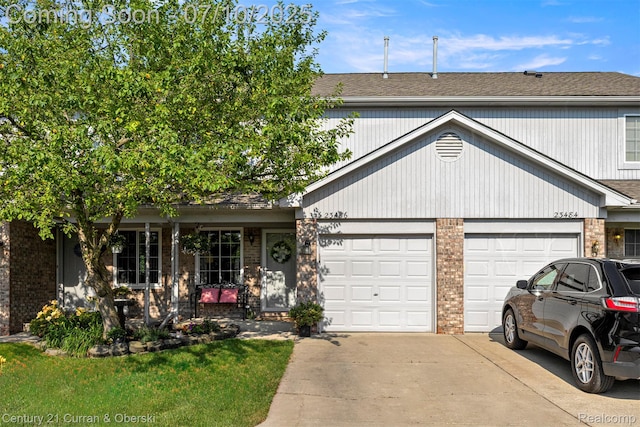 23486 Boller Ct, Trenton, MI 48183 - view of front of house featuring driveway, an attached garage, brick siding, and a shingled roof
