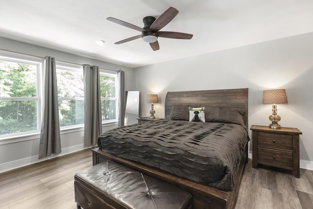 18734 Leonard Ct, New Buffalo, MI 49117 - bedroom with multiple windows, light wood finished floors, and a ceiling fan