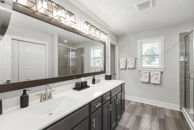 18734 Leonard Ct, New Buffalo, MI 49117 - bathroom with a shower stall, double vanity, and wood finished floors