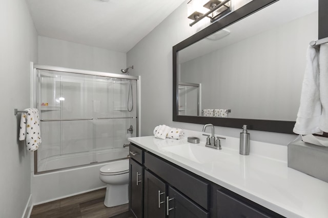 18734 Leonard Ct, New Buffalo, MI 49117 - full bathroom with vanity, wood finished floors, and bath / shower combo with glass door