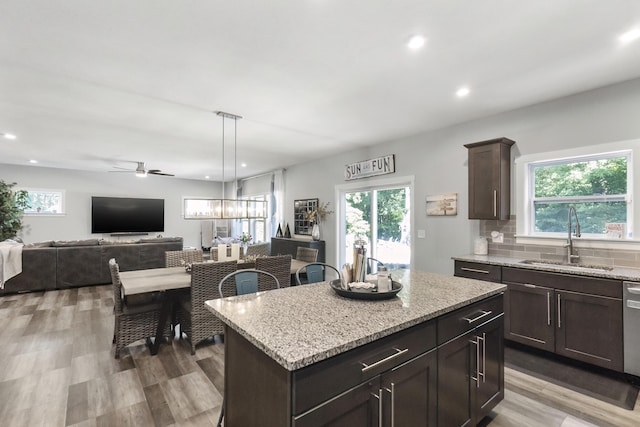 18734 Leonard Ct, New Buffalo, MI 49117 - kitchen with healthy amount of natural light, open floor plan, recessed lighting, light wood-style flooring, and light stone countertops