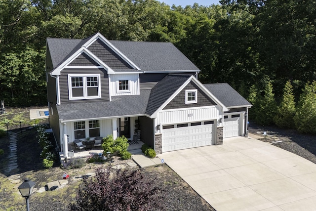 18734 Leonard Ct, New Buffalo, MI 49117 - craftsman house with covered porch, a garage, driveway, and a shingled roof