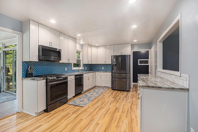 19160 Glendale Cir, Spring Lake, MI 49456 - kitchen with stainless steel appliances, light wood finished floors, tasteful backsplash, light stone countertops, and recessed lighting
