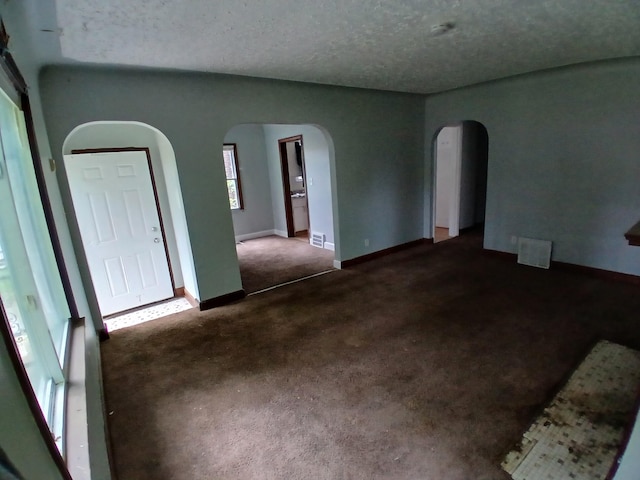 9729 Lakepointe St, Detroit, MI 48224 - carpeted empty room featuring arched walkways and a textured ceiling