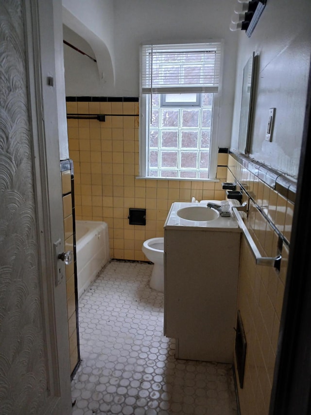 9729 Lakepointe St, Detroit, MI 48224 - full bath featuring tile walls, vanity, a tub, and a wainscoted wall