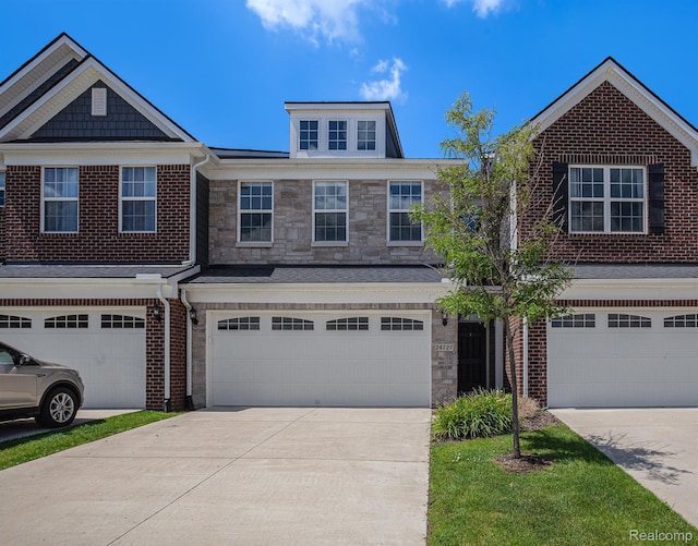 24727 Ivy Ln, Novi, MI 48375 - view of front facade featuring concrete driveway, an attached garage, stone siding, and brick siding