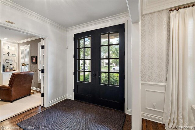 364 Chesterfield Ave, Birmingham, MI 48009 - entrance foyer featuring french doors, ornamental molding, dark wood-style floors, a wainscoted wall, and a decorative wall