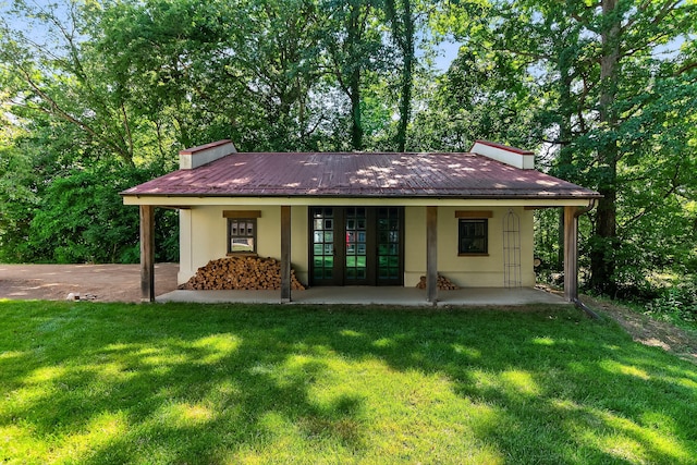 3420 Grange Rd, Berrien Springs, MI 49103 - rear view of house featuring a chimney, french doors, a lawn, and stucco siding