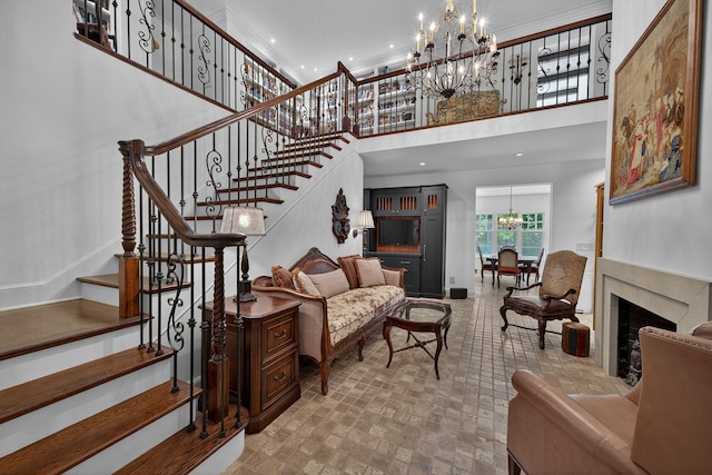 3420 Grange Rd, Berrien Springs, MI 49103 - stairs with a chandelier, a high ceiling, a premium fireplace, and brick patterned floors