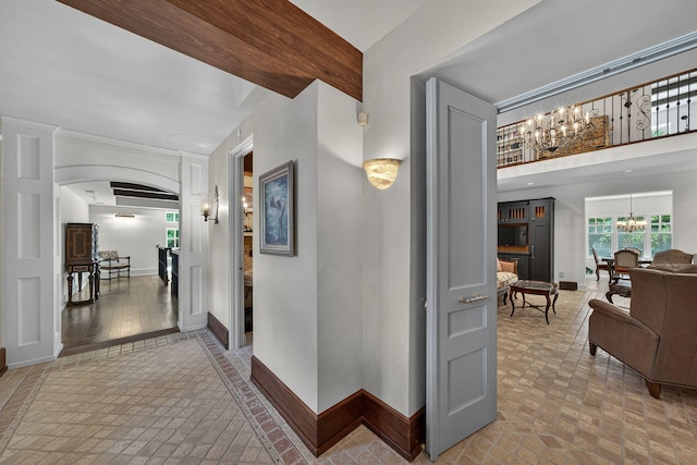 3420 Grange Rd, Berrien Springs, MI 49103 - hall with a chandelier, arched walkways, and brick patterned flooring
