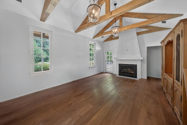 3420 Grange Rd, Berrien Springs, MI 49103 - unfurnished living room featuring beamed ceiling, healthy amount of natural light, dark wood finished floors, a chandelier, and a fireplace