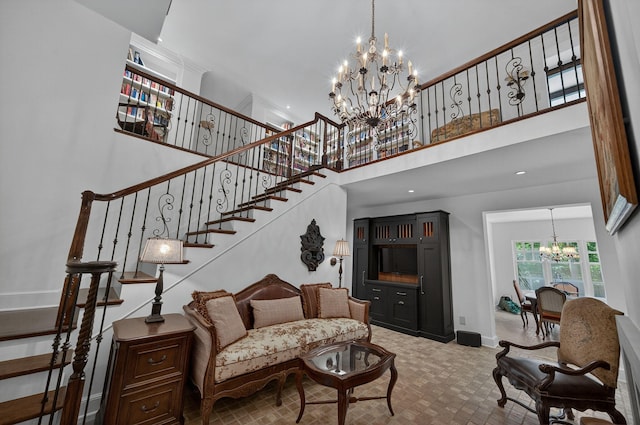 3420 Grange Rd, Berrien Springs, MI 49103 - living area with a chandelier, a towering ceiling, and stairs