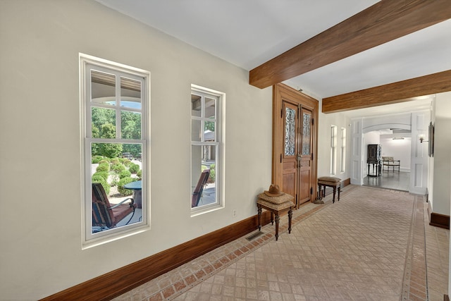 3420 Grange Rd, Berrien Springs, MI 49103 - hall featuring brick patterned floors, beamed ceiling, and arched walkways