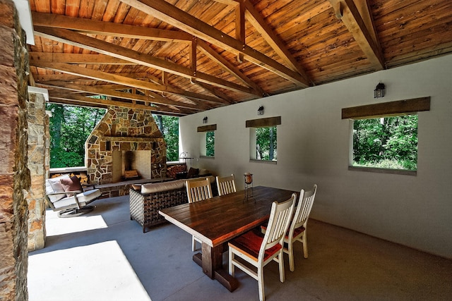 3420 Grange Rd, Berrien Springs, MI 49103 - dining area with carpet flooring, wood ceiling, and an outdoor stone fireplace