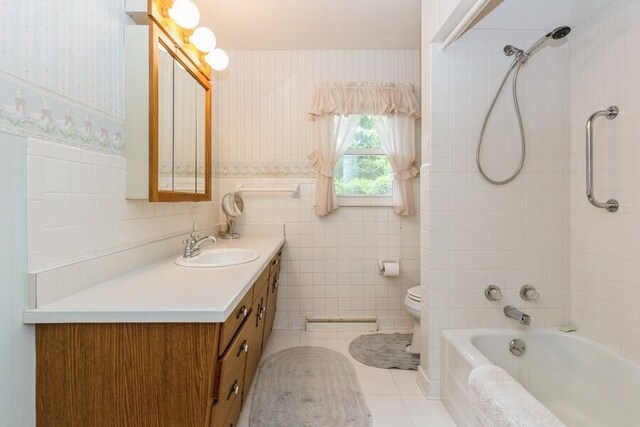 956 Vinewood Dr, Saint Joseph, MI 49085 - full bath with vanity, tile walls, bathing tub / shower combination, and tile patterned floors