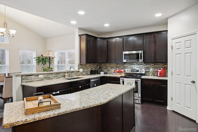 170 W Reed Lake Ct, Commerce Twp, MI 48390 - kitchen with appliances with stainless steel finishes, decorative backsplash, dark brown cabinets, dark wood finished floors, and light stone countertops