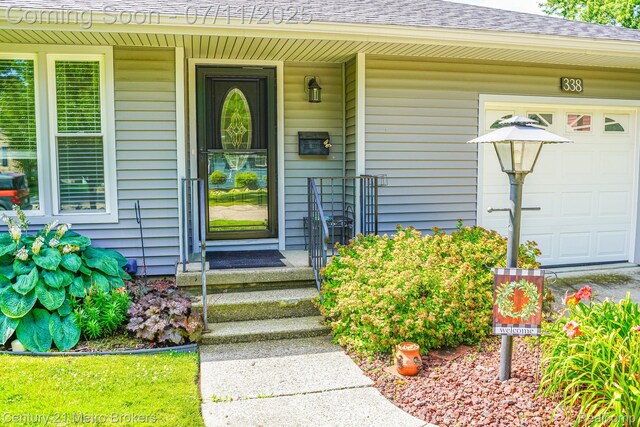 338 N Dr, Davison, MI 48423 - entrance to property featuring a shingled roof, a porch, and a garage
