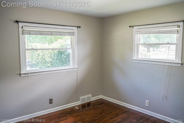 338 N Dr, Davison, MI 48423 - empty room with healthy amount of natural light and dark wood-style floors
