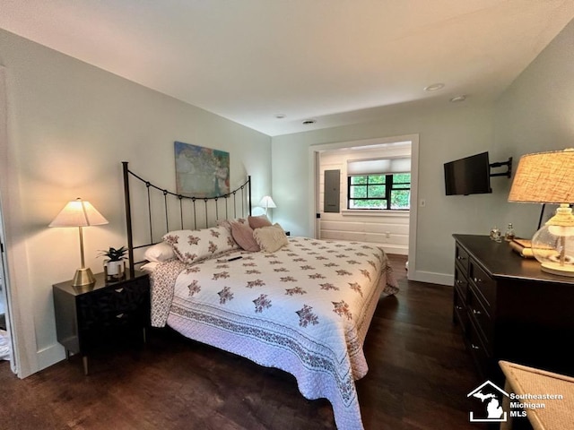 314 W Division St, Boyne City, MI 49712 - bedroom featuring baseboards and dark wood-style flooring