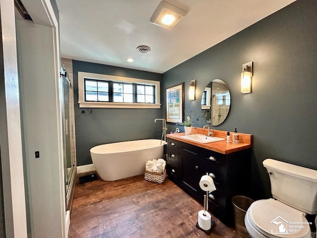 314 W Division St, Boyne City, MI 49712 - full bath with a freestanding tub, vanity, wood finished floors, and a shower stall