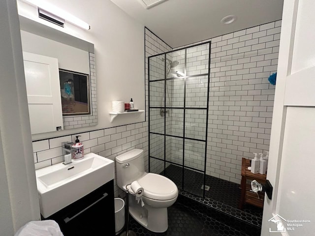 314 W Division St, Boyne City, MI 49712 - bathroom featuring tile walls, a walk in shower, vanity, and tile patterned flooring