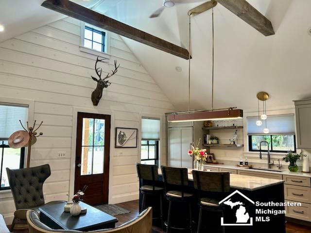 314 W Division St, Boyne City, MI 49712 - dining space with beam ceiling and high vaulted ceiling