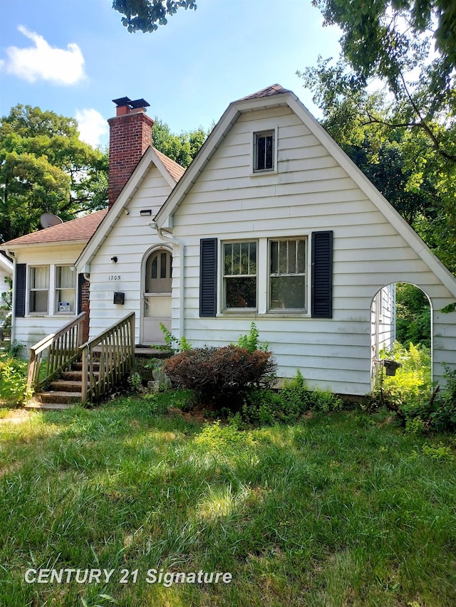 1205 Copeman Blvd, Flint, MI 48504 - bungalow-style home featuring a chimney and a front yard